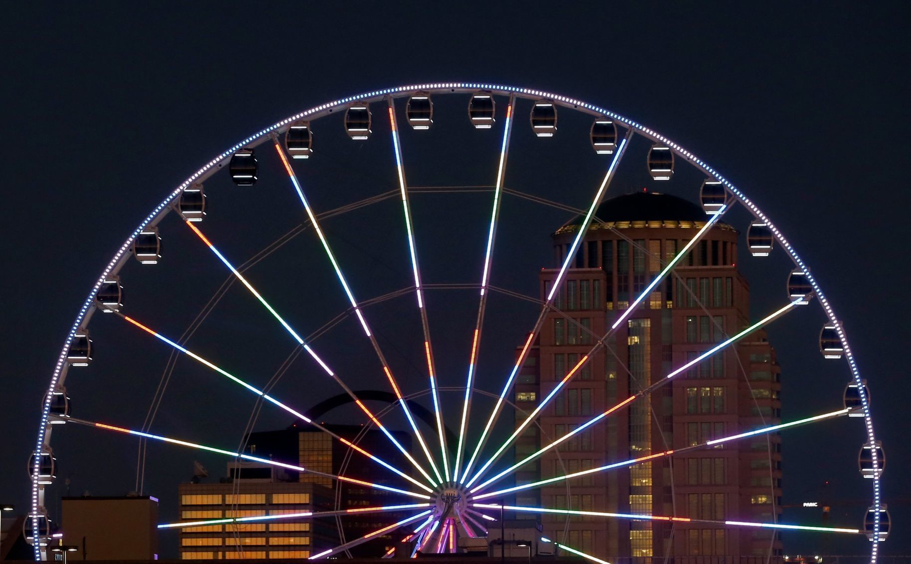 The St. Louis Wheel at Union Station lights up the sky